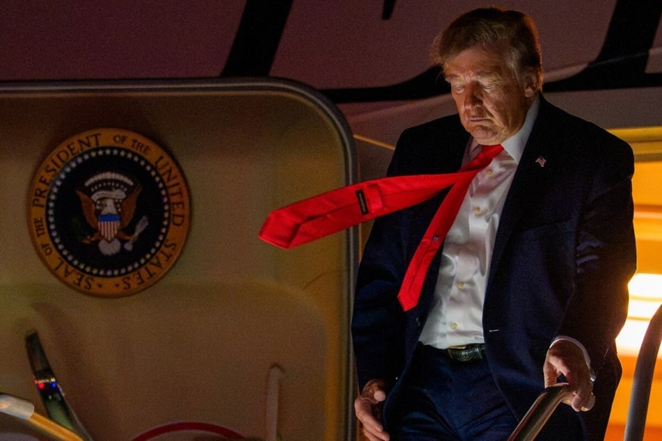 President Donald Trump arrives at Trump International Airport. The Trump administration shared a haunting and violent video of migrants on Halloween, sparking backlash.