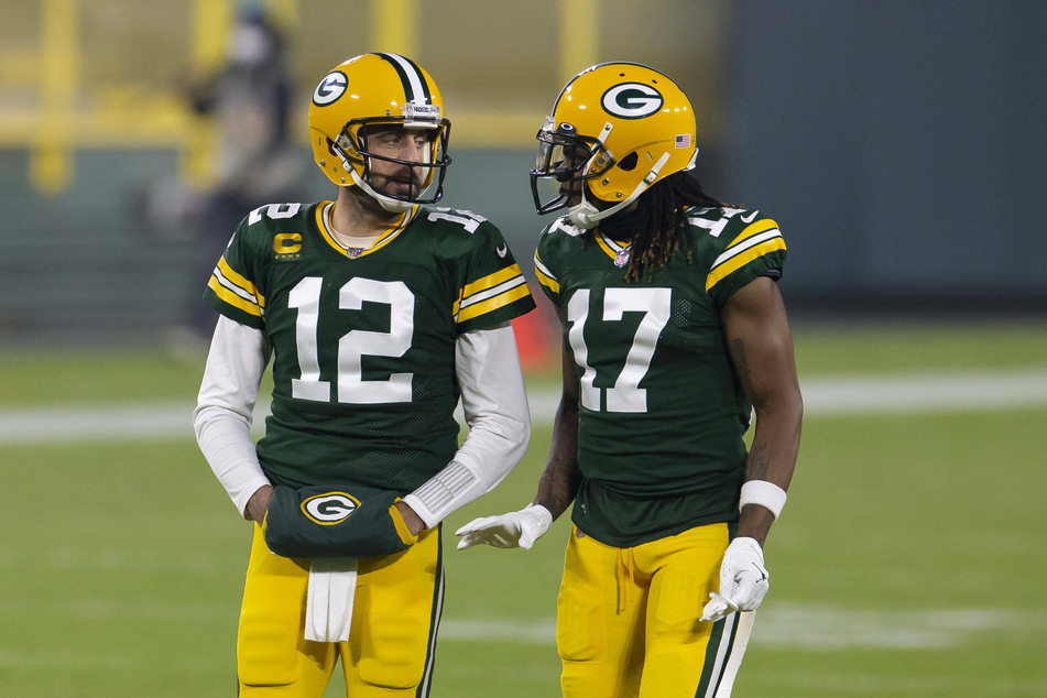 Packers quarterback Aaron Rodgers (l.) discusses a play with wide receiver Davante Adams (r.) during a game against the Carolina Panthers in Green Bay, Wisconsin.