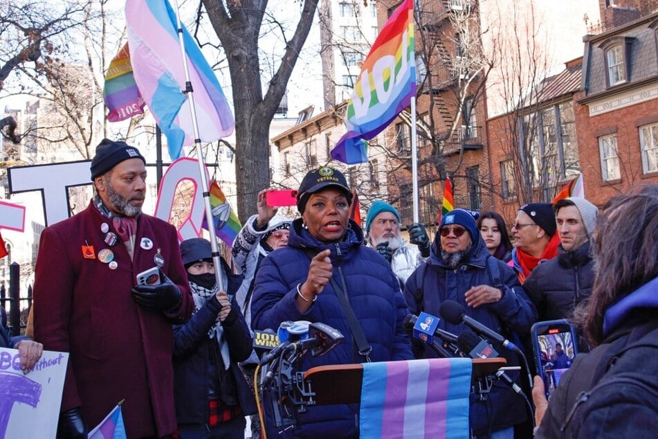 US Army veteran Tanya Walker (c.) speaks during a protest outside the Stonewall Inn, after the word transgender was erased from the National Park Service's webpage, in New York on February 14, 2025.