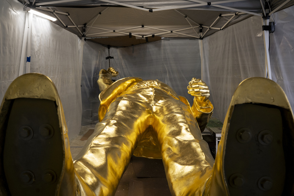 The 15-foot bronze statue coated with a thick layer of gold leaf of President Donald Trump lies in the studio of sculptor Alan Cottrill in Zanesville, Ohio, on February 5, 2026.