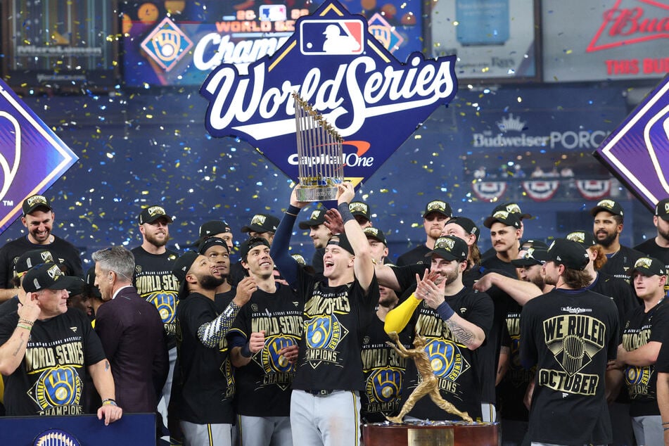 The Milwaukee Brewers celebrate with the Commissioner's Trophy after defeating the Tampa Bay Rays in game five of the 2026 World Series at Tropicana Field.