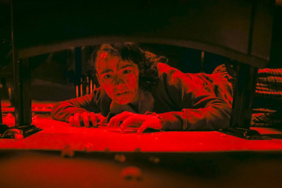 Clara Stack stars as Lilly Bainbridge, a high schooler who encounters "It" after a horrific massacre in a theater in the horror series, It: Welcome to Derry.