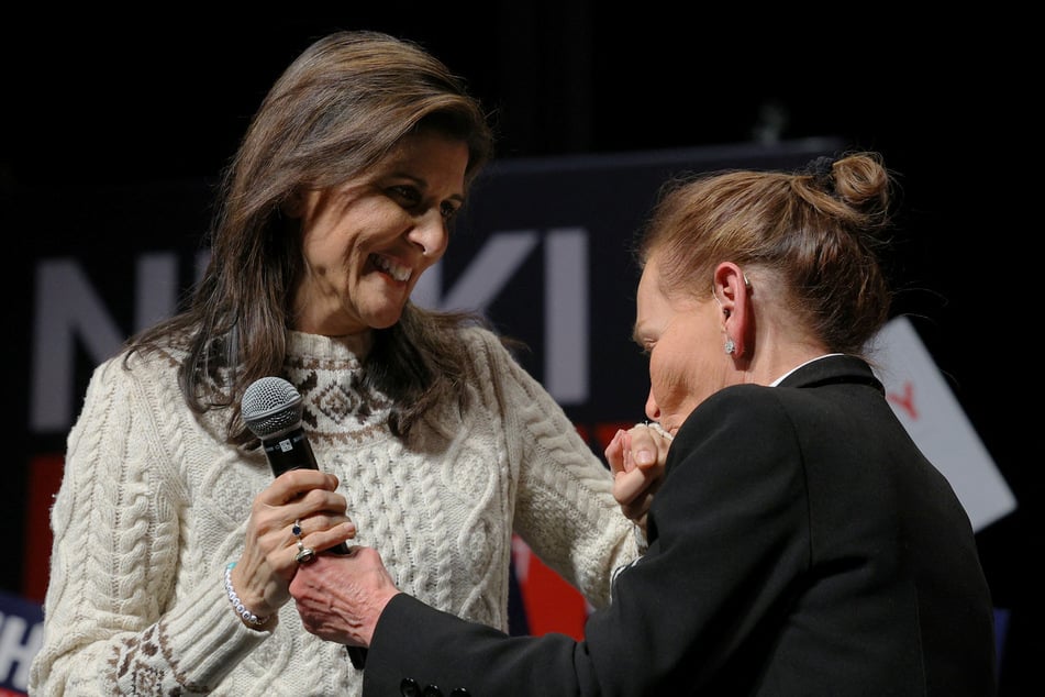 Republican presidential candidate Nikki Haley is welcomed to the stage by Judge Judy Sheindlin during a campaign rally in Exeter, New Hampshire.