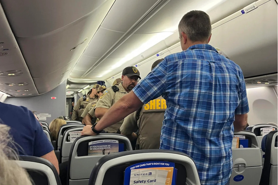 After landing in Madison, police officers escorted the passenger off the plane.