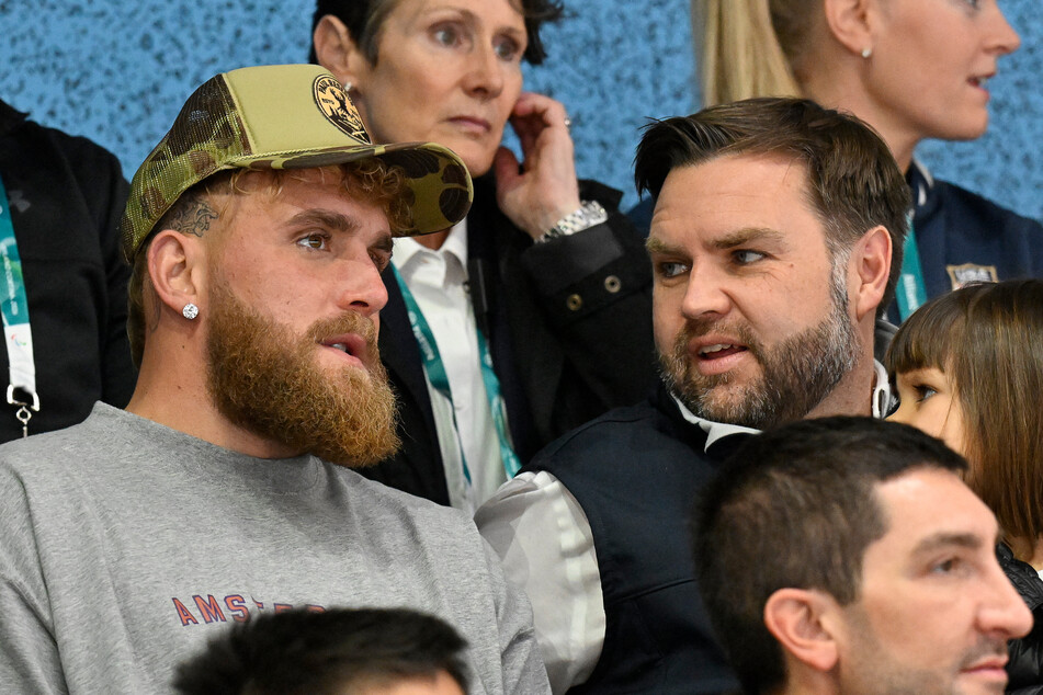 Jake Paul (l.) and Vice President JD Vance attend the women's ice hockey match at the Milano Cortina 2026 Winter Olympic Games on February 7, 2026.