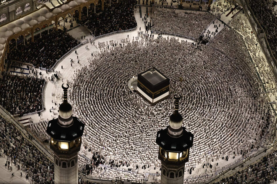 This aerial view shows the Grand Mosque complex in Mecca, as Muslims perform the evening prayer around the Kaaba, Islam's holiest shrine, on May 24, 2026.
