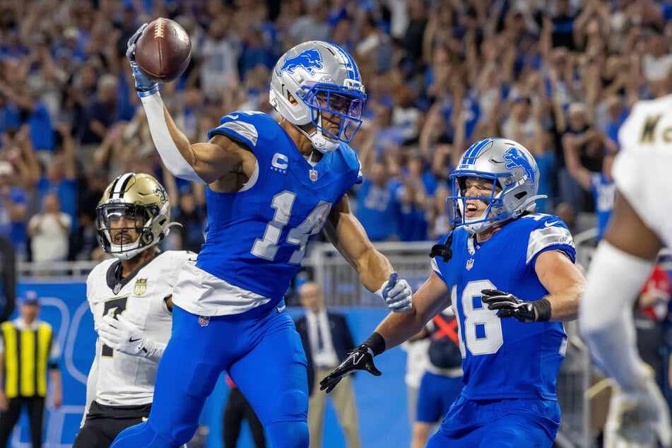 Detroit Lions wide receiver Amon-Ra St. Brown (l.) and wide receiver Isaac TeSlaa (r.) celebrate a touchdown against the New Orleans Saints in overtime at Ford Field.