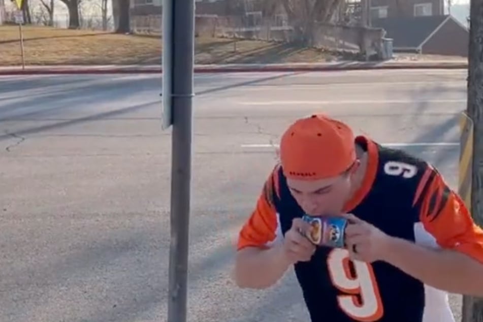 Bengal fan shotgunning a can of chili.