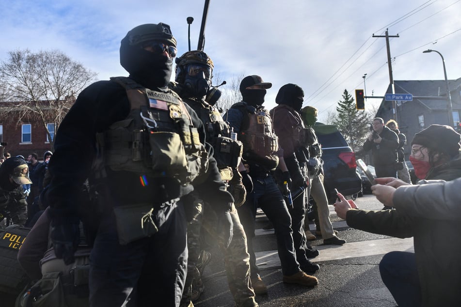 Protestors gather as ICE and other federal agents operate in Minneapolis, Minnesota, on January 13, 2026.