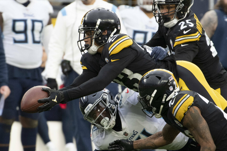 Steelers cornerback Joe Haden (c.) recovers a fumble in the third quarter.