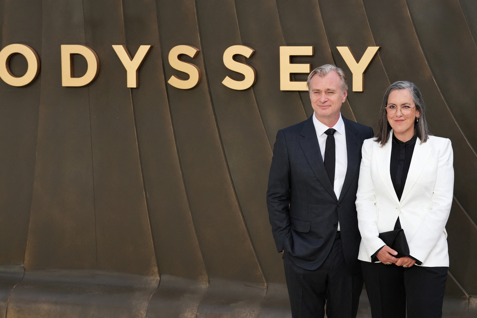 Director Christopher Nolan (l.) and producer Emma Thomas (r.) pose on the red carpet upon arrival to attend the world premiere of The Odyssey in London on July 6, 2026.