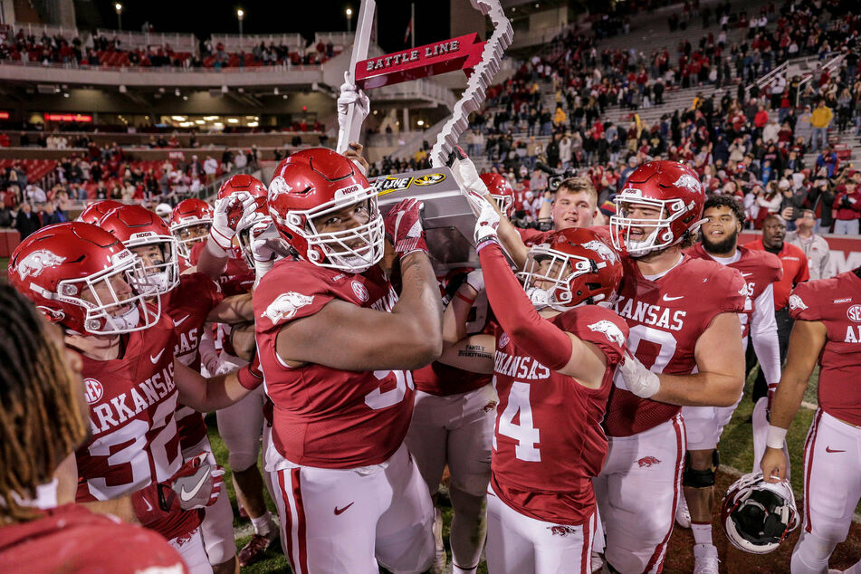 The Arkansas Razorbacks celebrate a win over the Missouri Tigers on November 26.