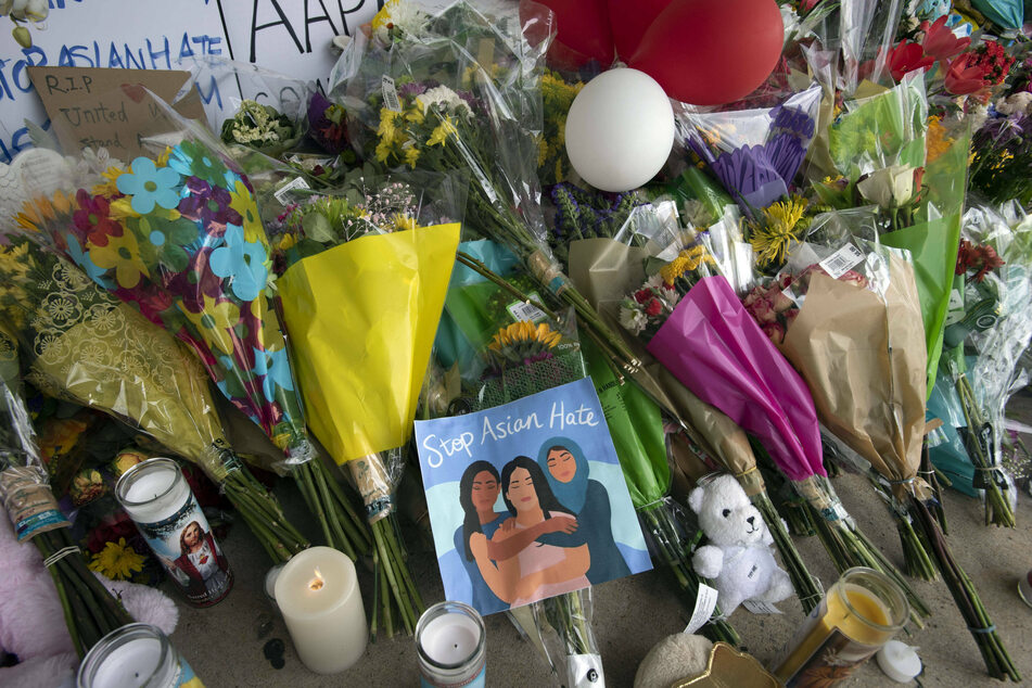 Flowers and memorials were placed outside Youngs Massage Spa, a week after eight people were shot to death at three Atlanta area massage spas.