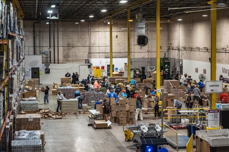 Volunteers prepare boxes of food for the food bank beneficiaries in a warehouse at the Community Food Bank of Southern Arizona, in Tucson, Arizona, on October 17.
