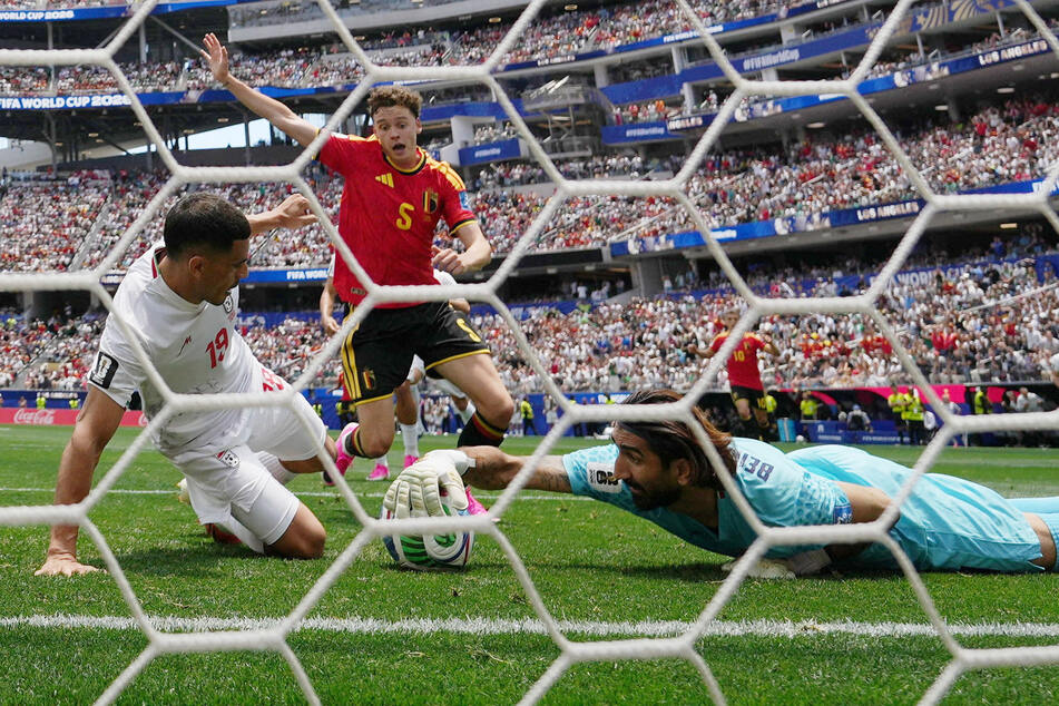 Iran's Alireza Beiranvand makes a save against Belgium in their World Group G match on June 21, 2026.
