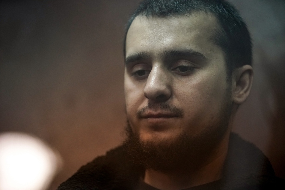 Moscow attack suspect Dilovar Islomov (pictured) inside the defendant's cage as he waits for his pre-trial detention hearing at the Basmanny District Court in Moscow on Monday.