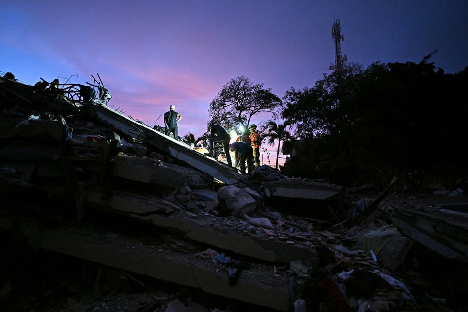 Volunteers and Ecuadorean firefighters of the Urban Search and Rescue search for bodies at the site of a collapsed building in Caraballeda, La Guaira State, Venezuela, on June 28, 2026.
