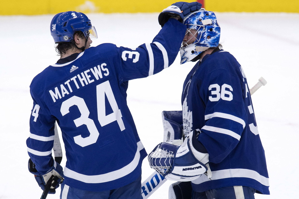 Maple Leafs center Auston Matthews (34) and goaltender Jack Campbell (36)