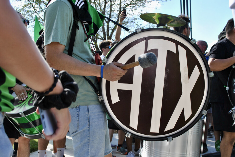 A member of La Murga de Austin pounds his drum while waiting for the Austin FC players to arrive at Q2 Stadium.
