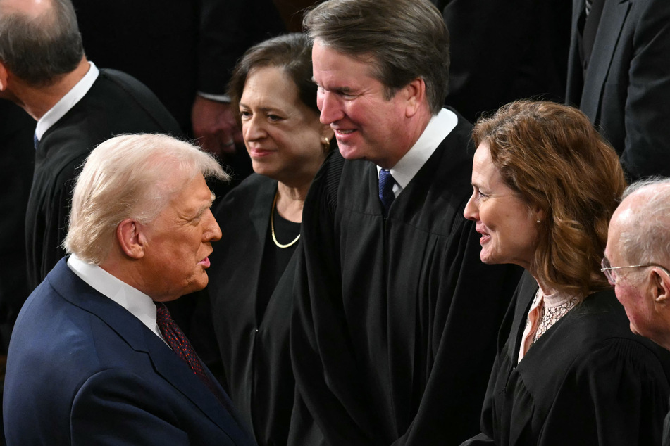 President Donald Trump (l.) shakes hands with Supreme Court Associate Justice Amy Coney Barrett as he arrives to address a joint session of Congress on March 4, 2025.