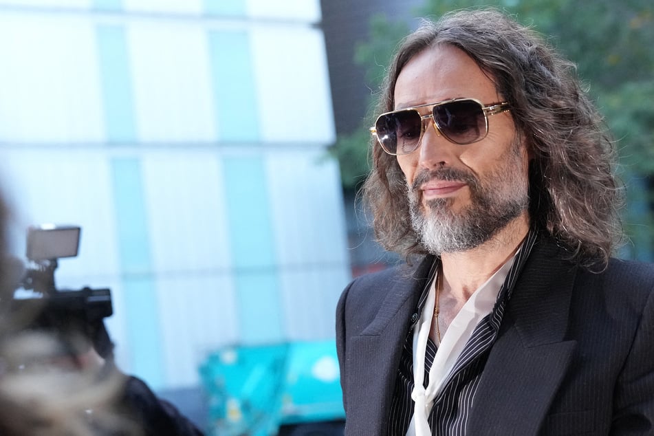 British comedian Russell Brand arrives at Southwark Crown Court in London on Wednesday for the start of his trial. Prosecutors called the 51-year-old a "ruthless" predator as his sexual assault trial opened.