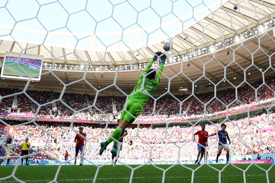 Costa Rica's Keysher Fuller scores their first goal past Japan's Shuichi Gonda.