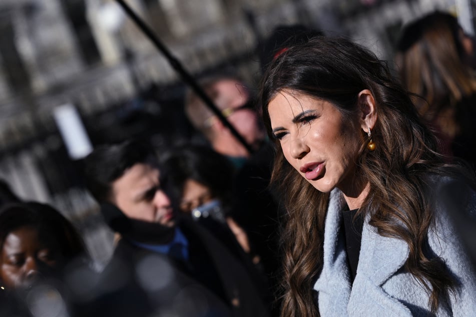 Homeland Security Secretary Kristi Noem speaks to reporters following a television interview outside of the West Wing of the White House on January 15, 2026.