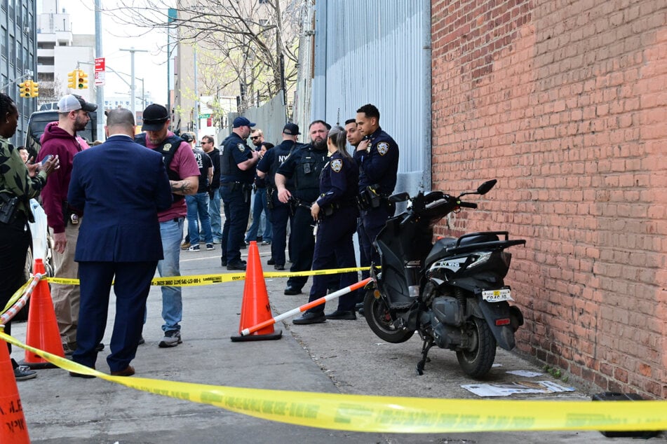 Members of the NYPD Crime Scene Unit investigate the crime scene in Brooklyn.