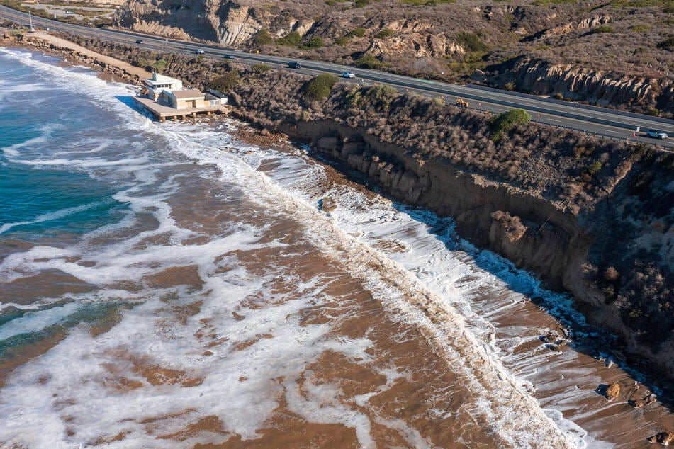 A portion of the Southern California coast shows damage from unusually high surf on October 14. The fractured bluff is visible after months of powerful waves, driven by recent hurricanes and El Niño conditions, battered the coastline.