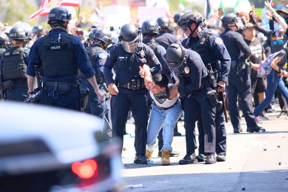 Hundreds of protesters gathered in Los Angeles, California, demanding an immediate halt to Immigration and Customs Enforcement (ICE) raids at workplaces on June 8, 2025.