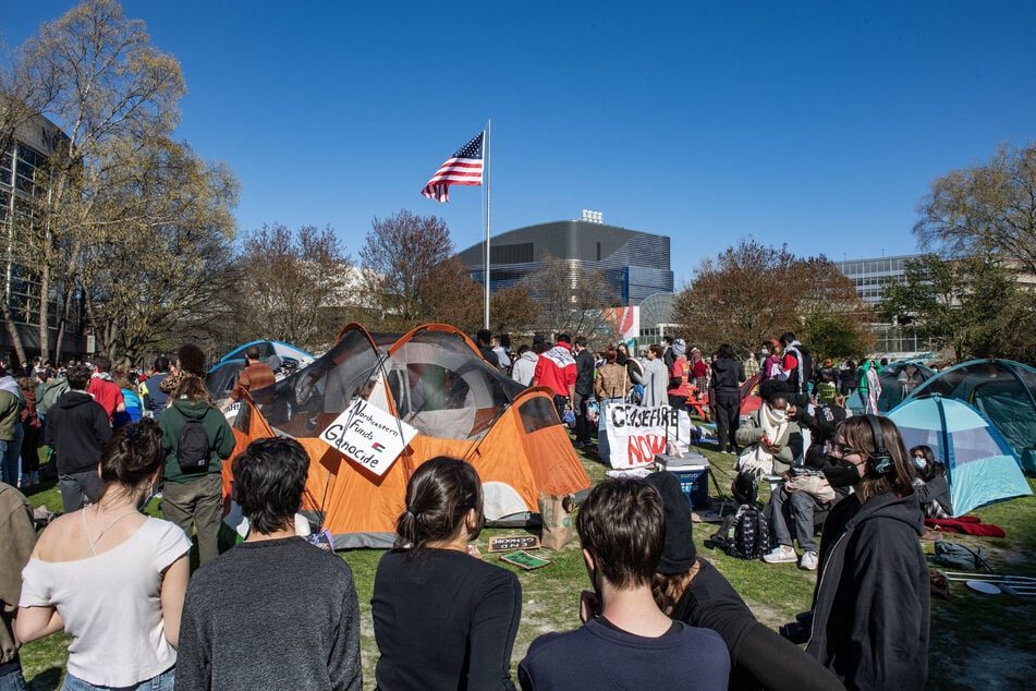 Pro-Palestinian protesters create a human chain around an encampment set up at Northeastern University in Boston, Massachusetts, on Thursday.