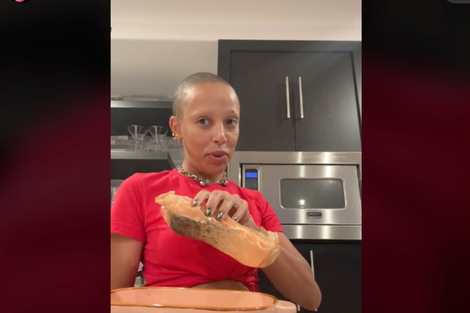 Doja Cat shows off the fish she's about to cook on TikTok.