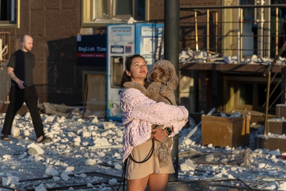 A resident stands outside a damaged residential building, where 17 people were injured, following aerial attacks that targeted a Ukrainian city on the Black Sea coast on September 12, 2026. War-related objects found in the Black Sea have more than doubled in six months amid the Russia-Ukraine conflict.