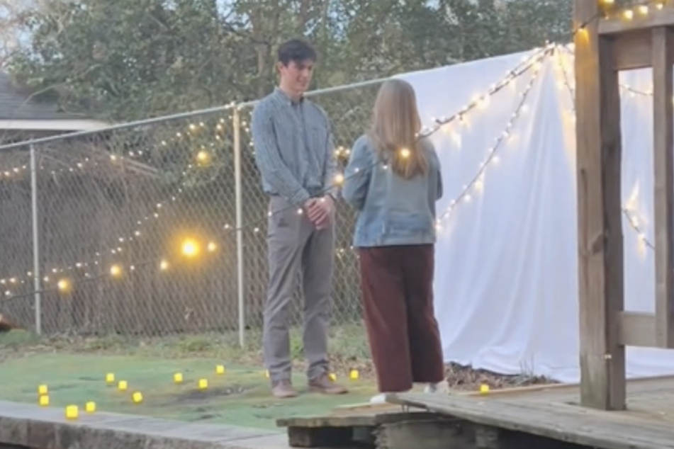 This couple's special moment got upstaged by a curious raccoon!