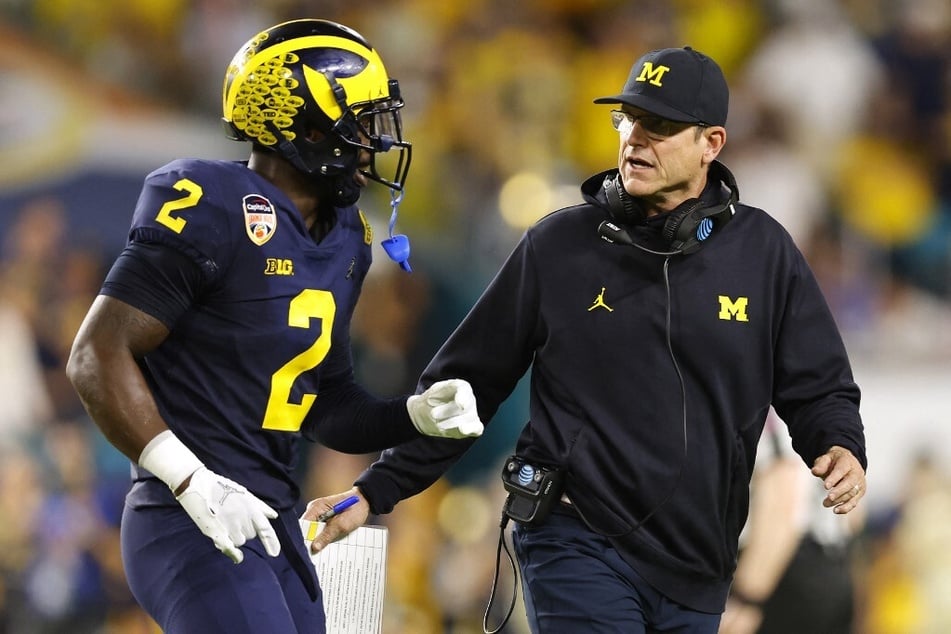 Jim Harbaugh (r) is reportedly scheduled for a second interview with the Atlanta Falcons on Wednesday while currently negotiating a contract with the Chargers.