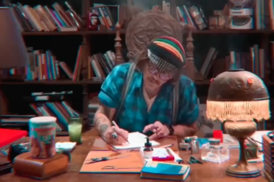 Johnny Depp writing a thank-you note to fans for their support.