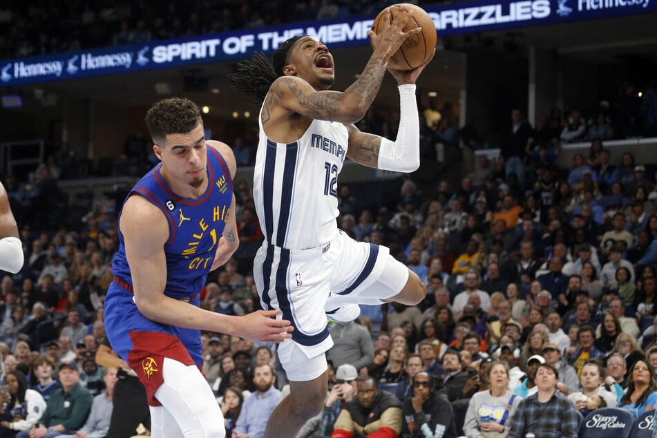 Memphis Grizzlies guard Ja Morant drives to the basket as Denver Nuggets forward Michael Porter Jr. defends during the second half at FedExForum.