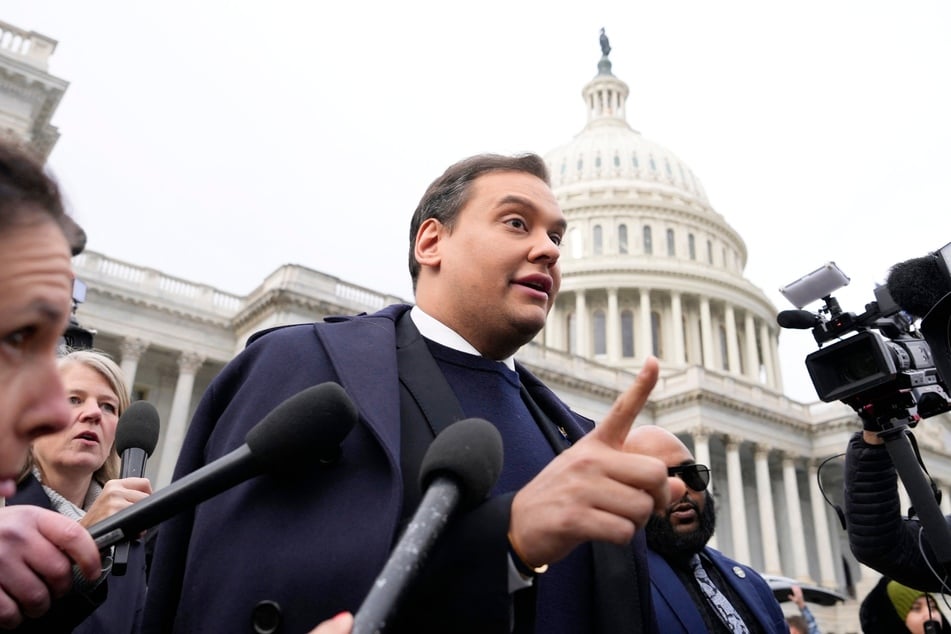 George Santos surrounded by journalists as he leaves the US Capitol after his fellow members of Congress voted to expel him from the House of Representatives on December 01, 2023.