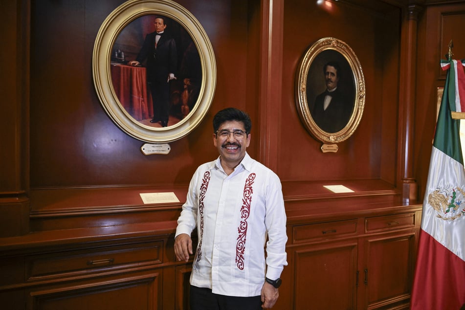 Mexico's Supreme Court Chief Hugo Aguilar Ortiz poses in front of a portrait of former President Benito Juarez on August 13, 2026.