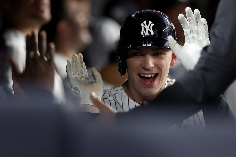 Ben Rice #22 of the New York Yankees celebrates after hitting a home run against the Boston Red Sox in Game 1 of the American League Wild Card Series on Tuesday. The Yankees dominated with a 9-0 shutout win.