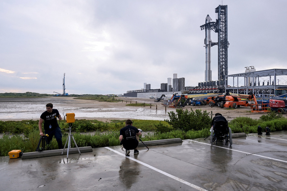 Photographers setup remote cameras for the SpaceX Starship launch on its 10th test flight at the company's complex in Texas on August 24, 2025.