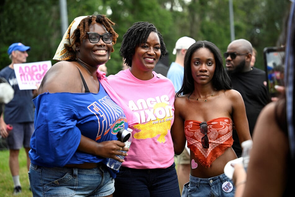Angie Nixon poses with supporters while campaigning on the campus of the University of Florida in Gainesville on September 5, 2026. The Senate hopeful has said she is open to a conversation about reparations for Black Americans.