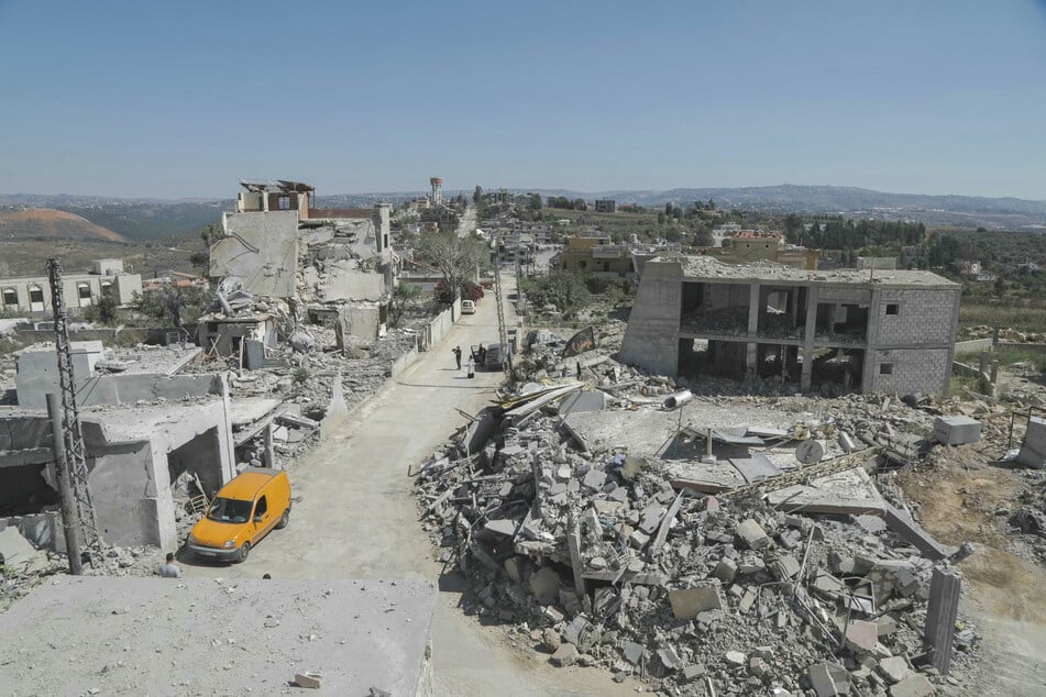 A man walks past destruction in the southern Lebanese village of Froun on June 30, 2026.