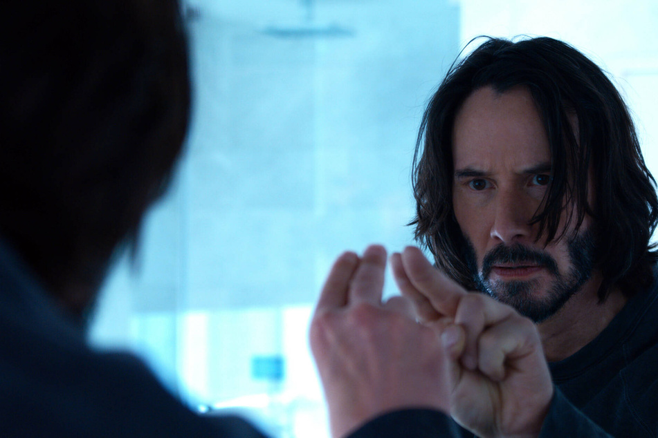 Keanu Reeves returns as Neo/The Chosen One in The Matrix Resurrections.