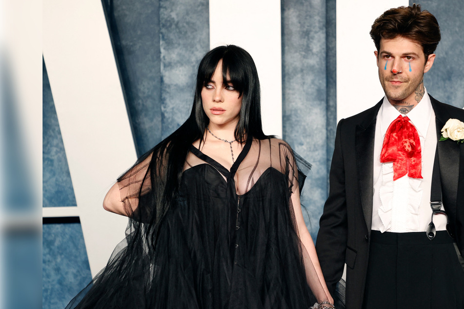 Billie Eilish turns heads and takes a tiny tumble on Oscar party red carpet