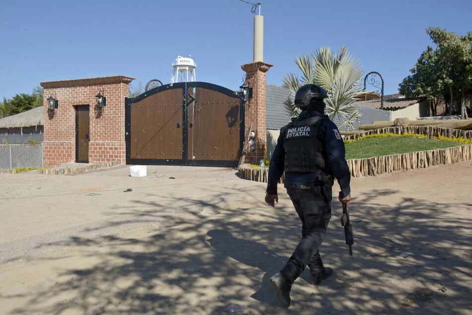 A police officer walks outside the mansion where Ovidio Guzman was arrested on January 5, 2023, in the Jesus Maria area in Culiacan, Sinaloa State, Mexico.