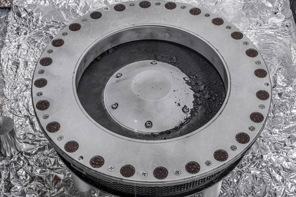 NASA researchers have been focused on "bonus particles" – the black dust coating the sample collector.