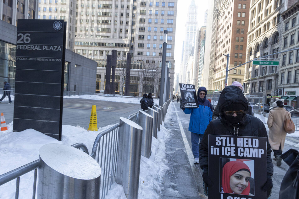 Protesters holding signs that read "Still Held in ICE Camp" with Leqaa Kordia's image during a vigil outside of 26 Federal Plaza in New York City on February 5, 2026.