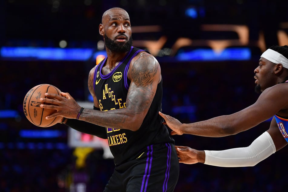 Los Angeles Lakers forward LeBron James controls the ball against Oklahoma City Thunder guard Luguentz Dort during the first half in game four of the second round of the 2026 NBA Playoffs at Crypto.com Arena.