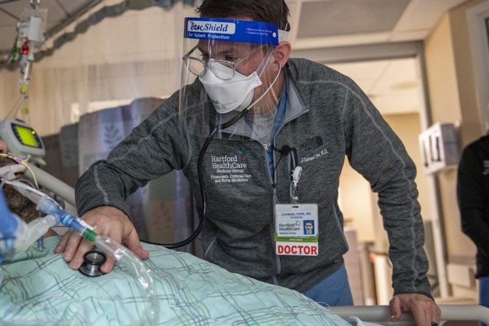 A doctor treats a patient suffering from the effects of Covid-19 in the ICU at Hartford Hospital in Connecticut.